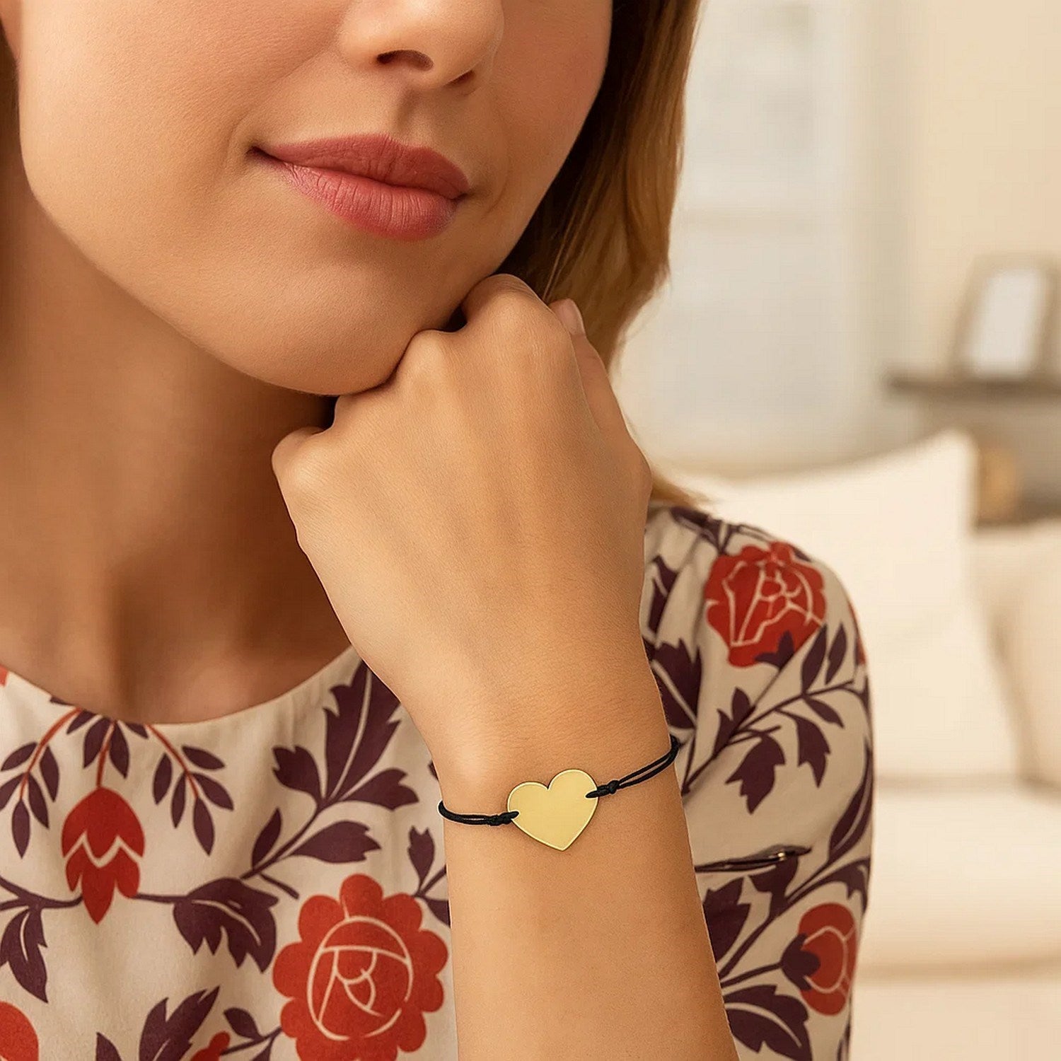 Black cord adjustable bracelet with a 14k yellow gold heart charm.