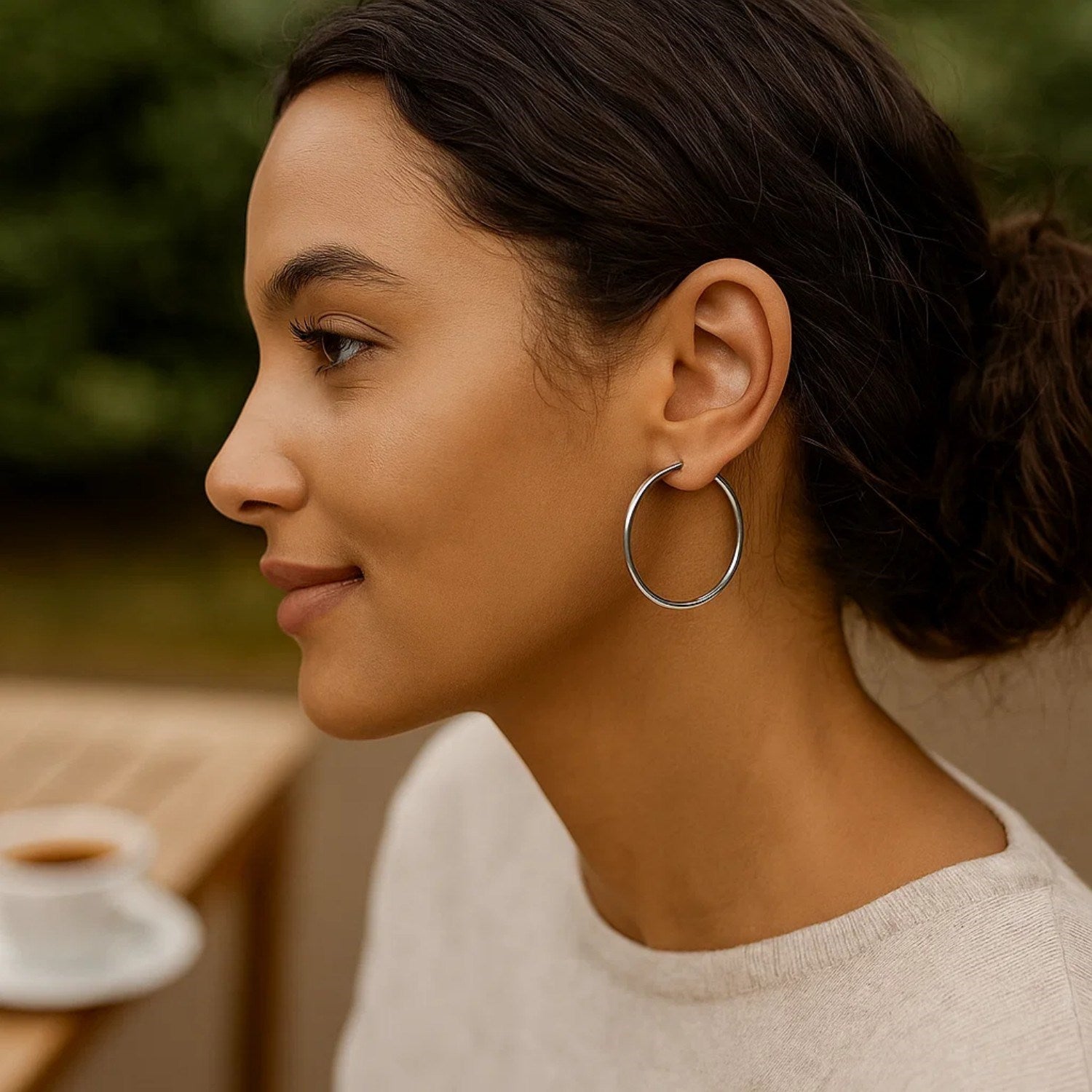 Sterling silver rhodium plated large polished classic hoop earrings.