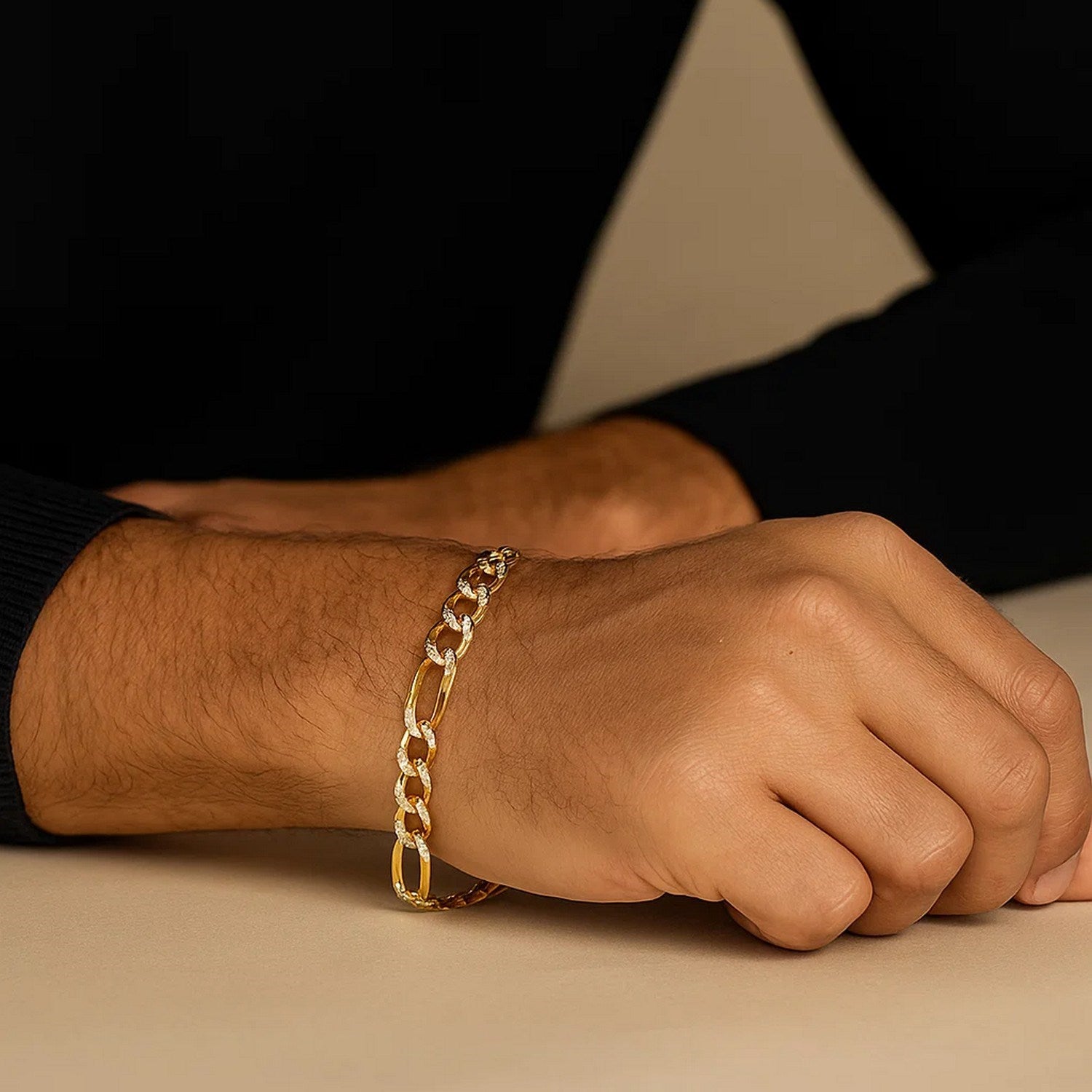 14K yellow two-tone solid pave figaro bracelet on a man's wrist.