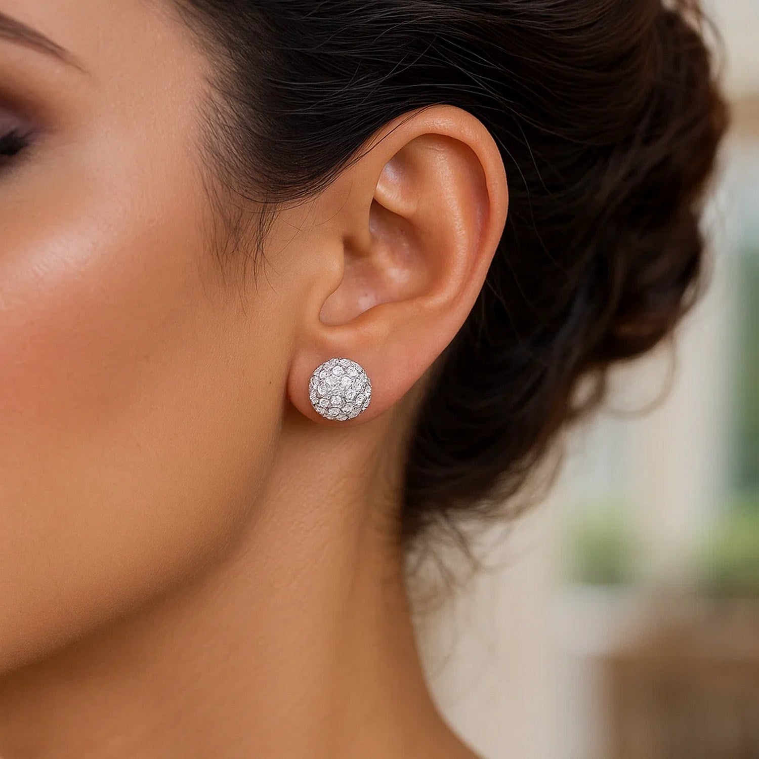 White Tone Crystal Ball Stud Earrings in 14k Yellow Gold (8mm) on a model's ear.