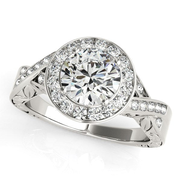 Halo set diamond engagement ring in 14k white gold with a round center stone.