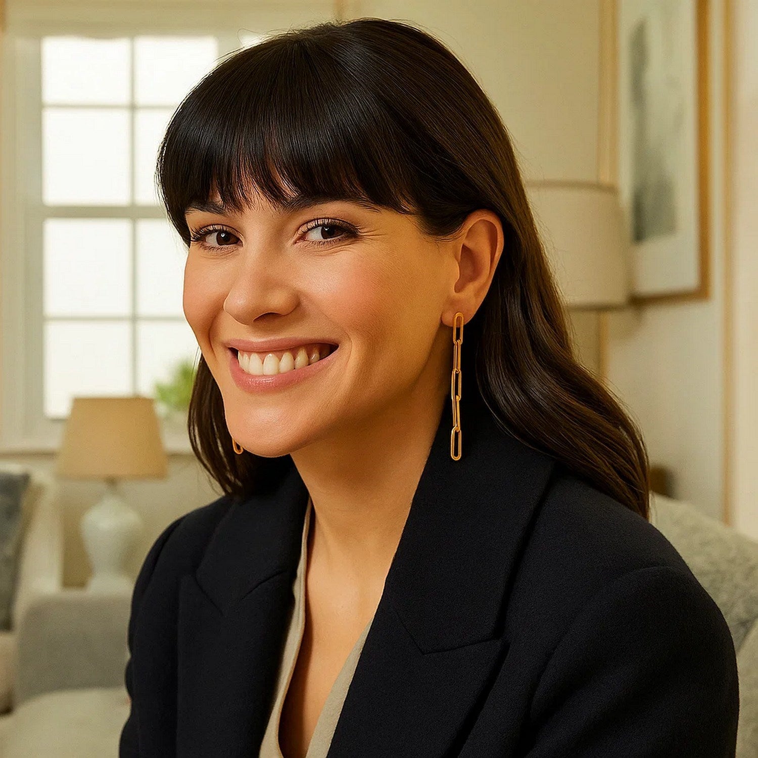 14K yellow gold five-link paperclip chain earrings on a smiling woman.