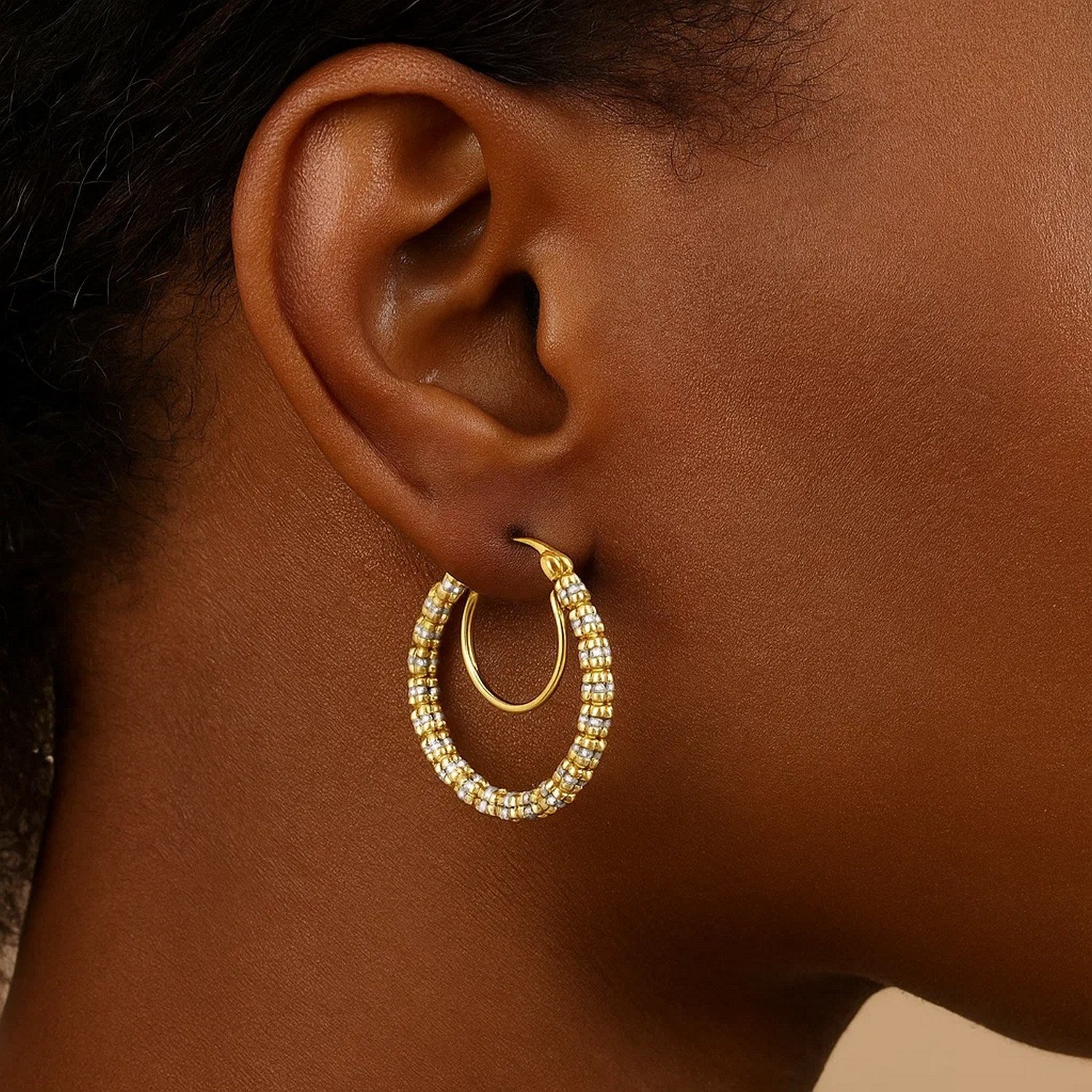 14K two-tone gold iced round hoop earrings with a smaller gold hoop inside.