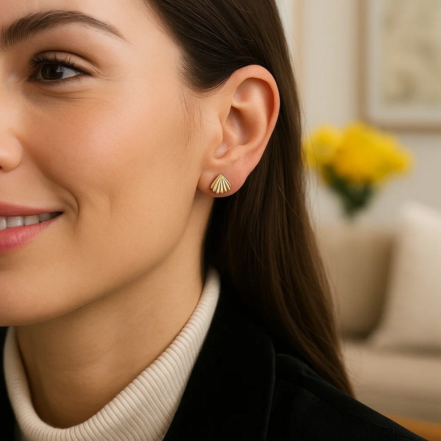 Sea Shell Stud Earrings in 10K Yellow Gold on a woman's ear.