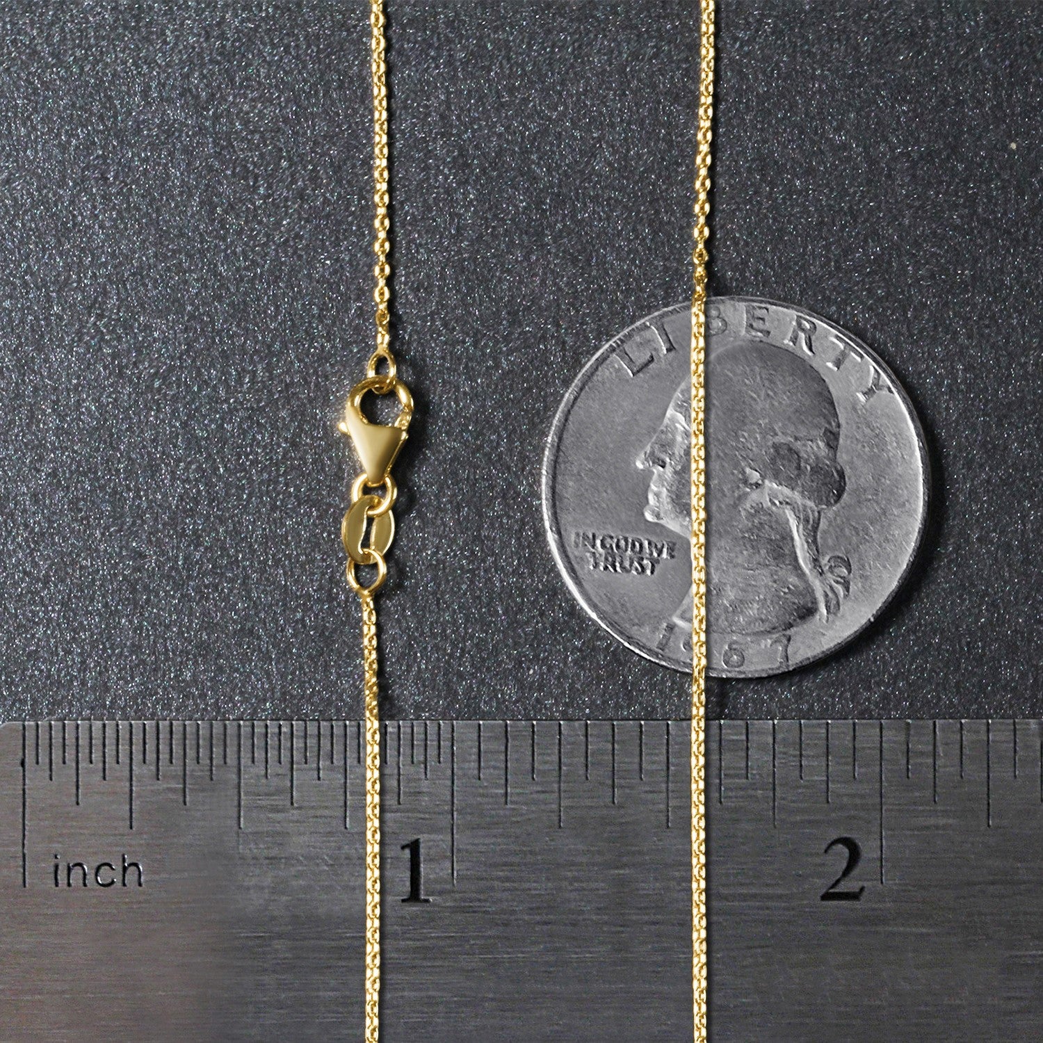 An 18k yellow gold round cable link chain with a lobster clasp, shown with a ruler and coin.