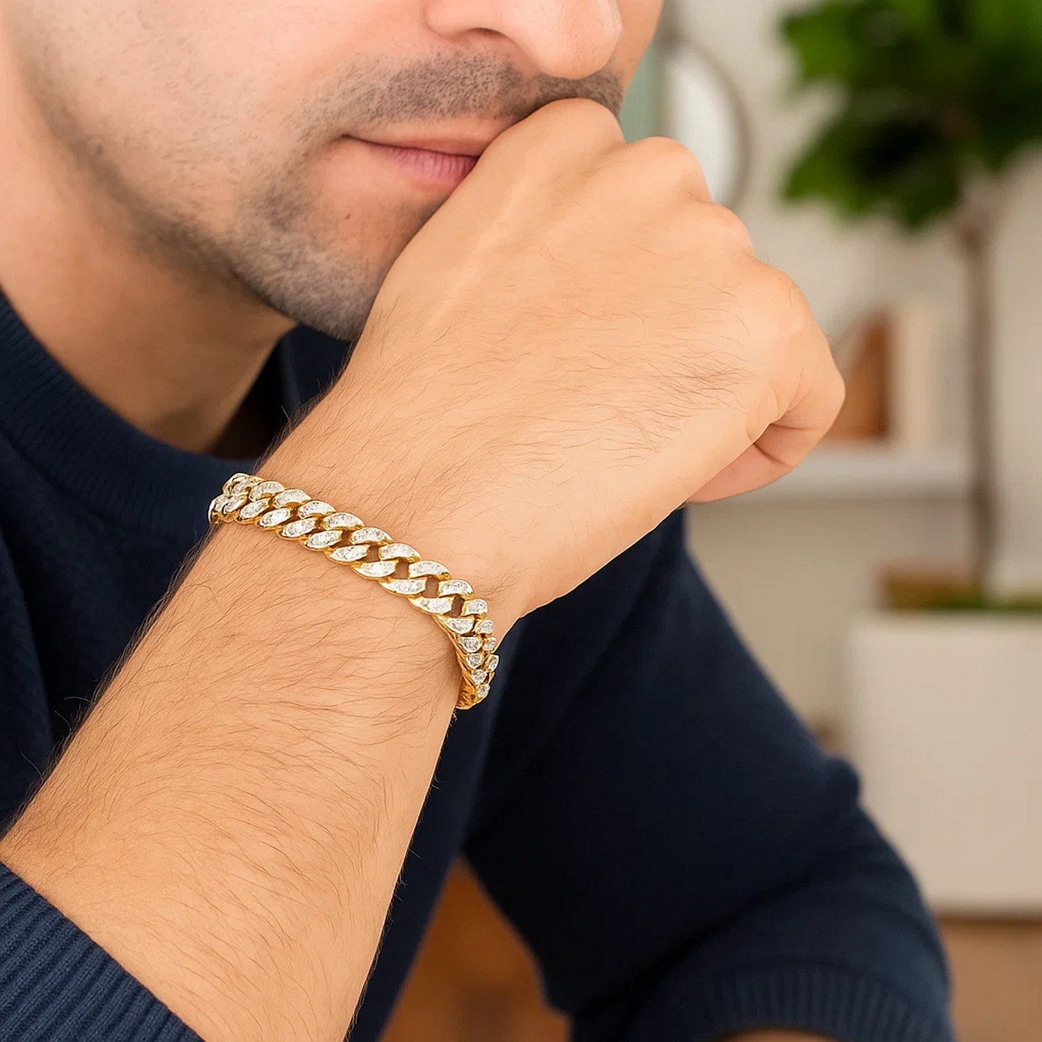 14k yellow gold Miami Cuban bracelet with white pave diamonds on a man's wrist.