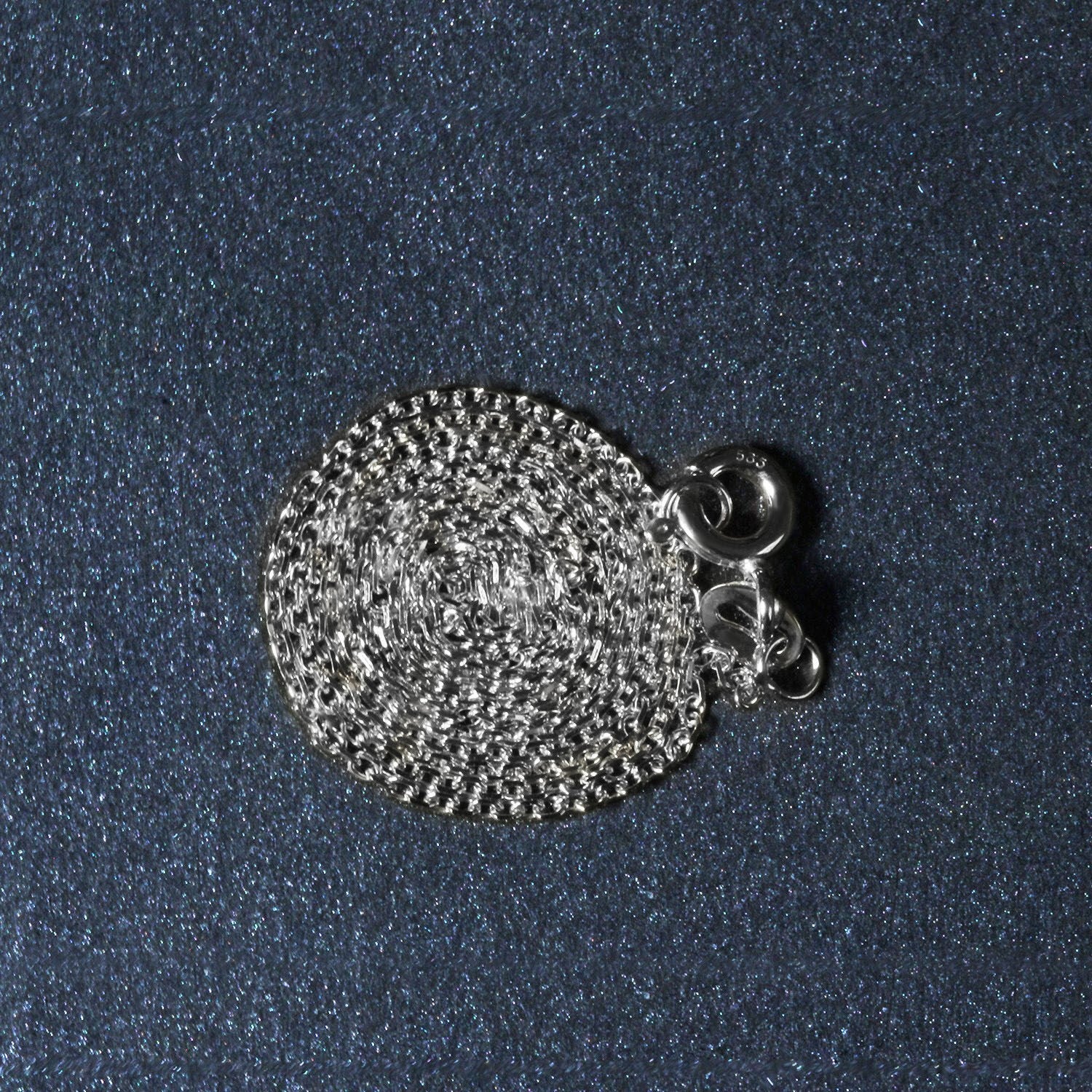 18k white gold diamond cut cable link chain with a spring ring clasp.