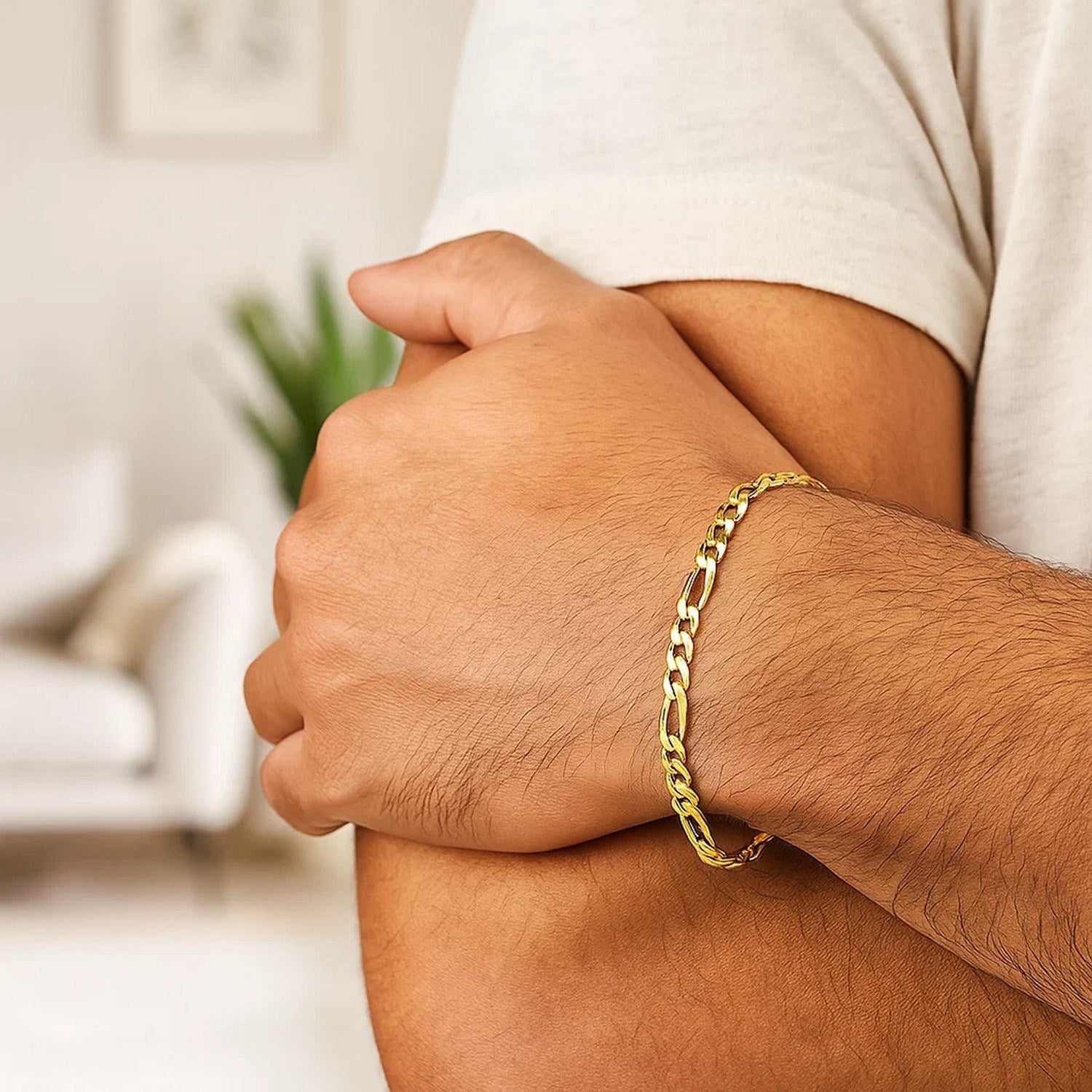 10k yellow gold Figaro bracelet on a person's arm.