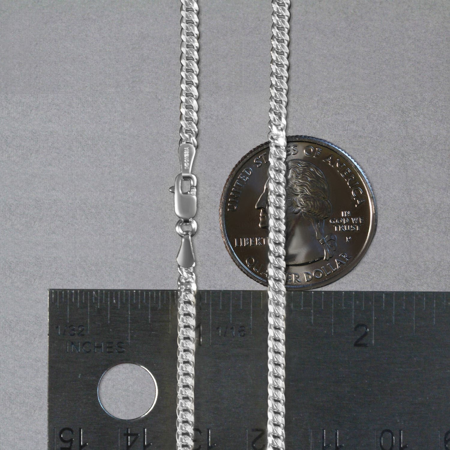 A 14K white gold gourmette chain with a lobster clasp, shown next to a quarter and ruler.