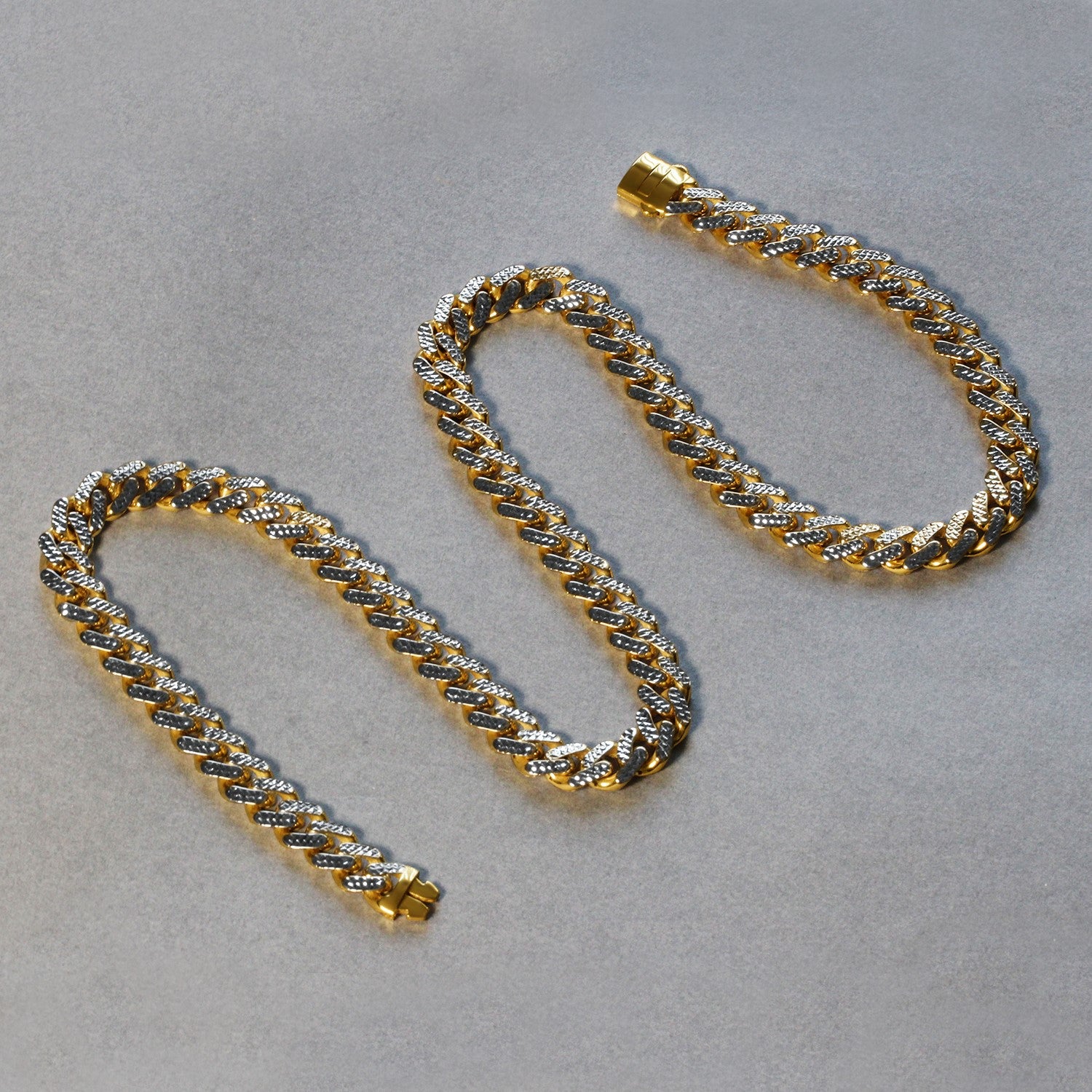 Two 14k two-tone gold Miami Cuban chain necklaces with white pave.