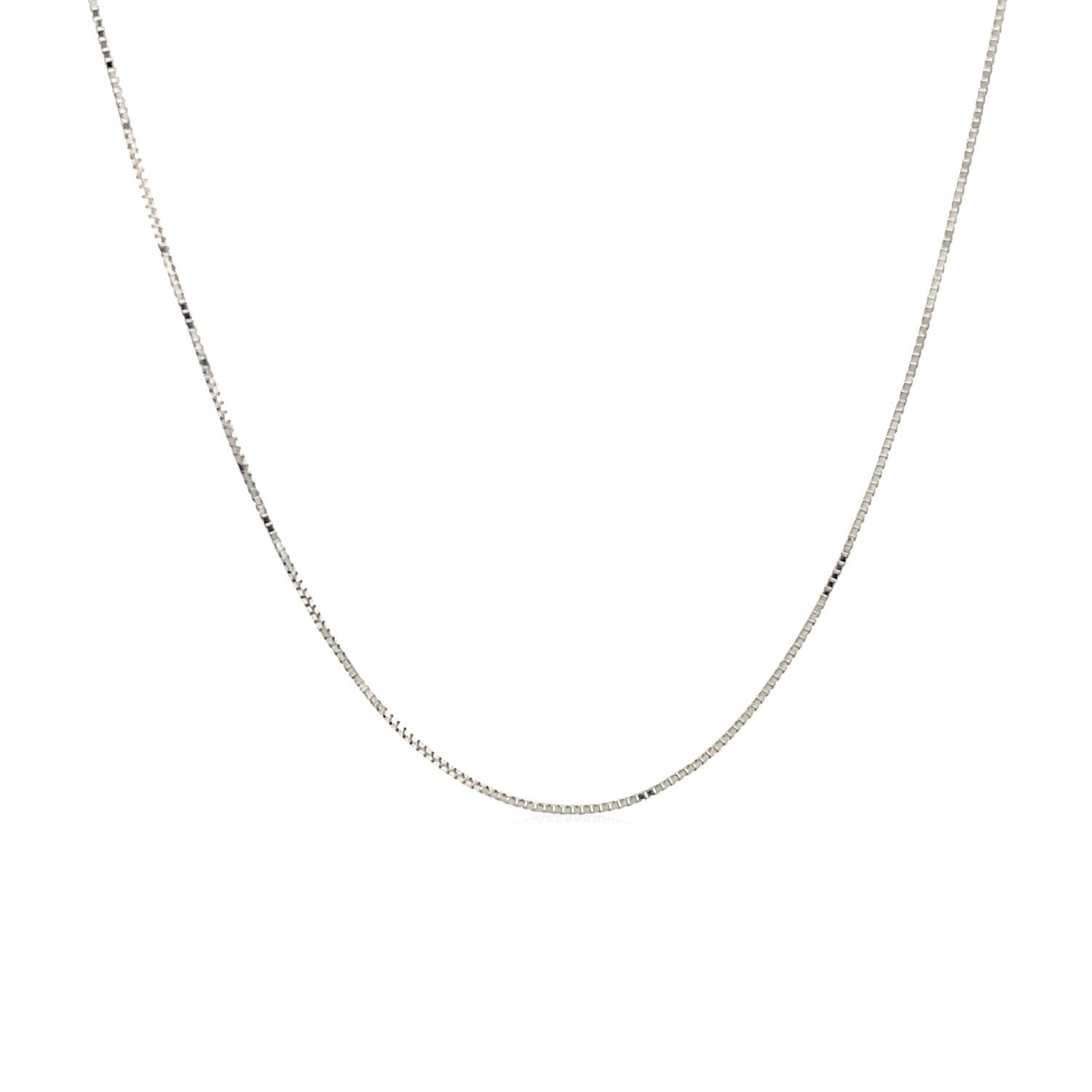 A delicate 14k white gold box chain is draped in a gentle curve.