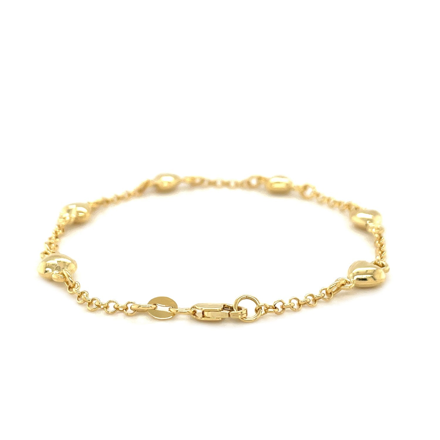 14k yellow gold rolo chain bracelet with puffed heart stations and a lobster clasp.