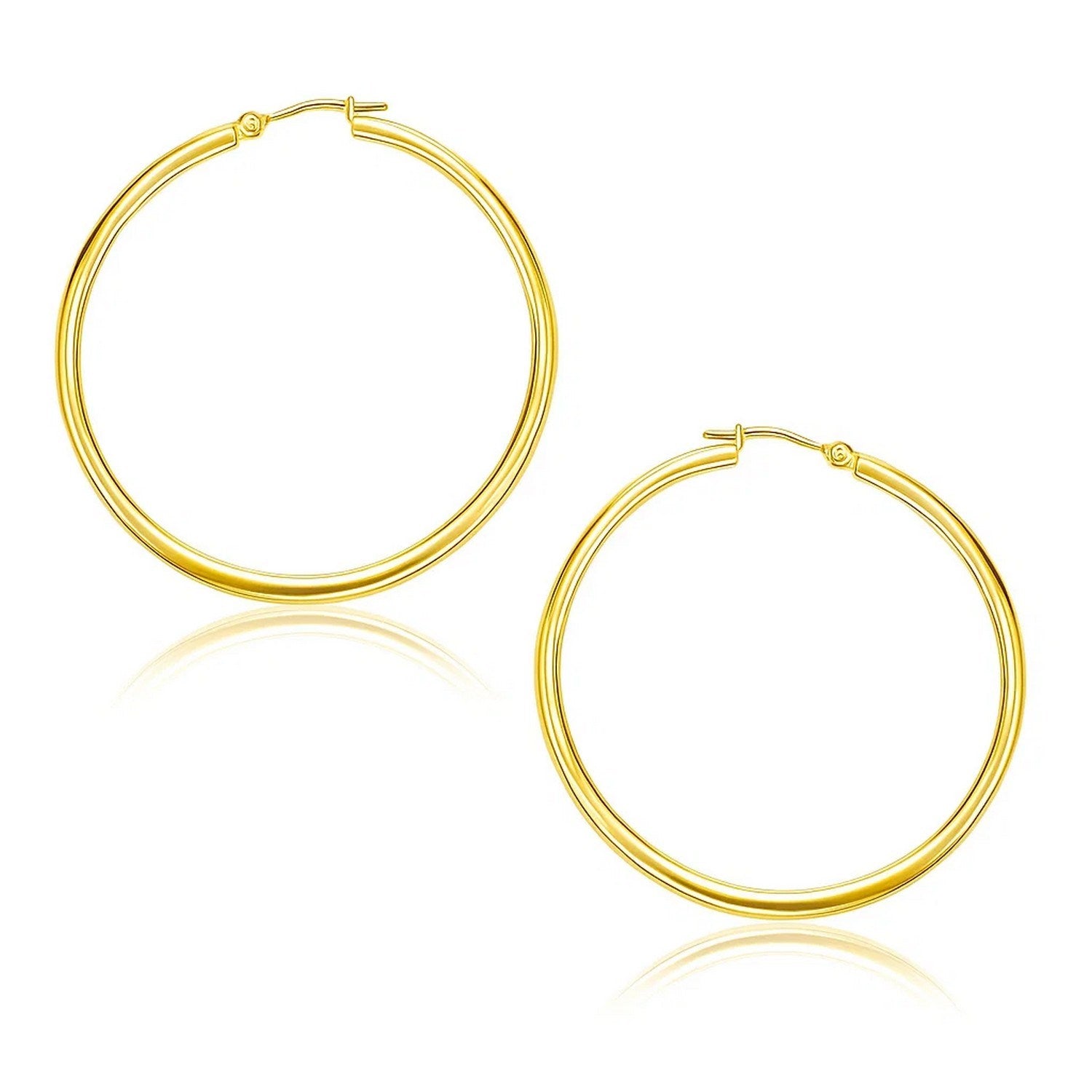 A pair of polished 10k yellow gold hoop earrings with snap lock backings.