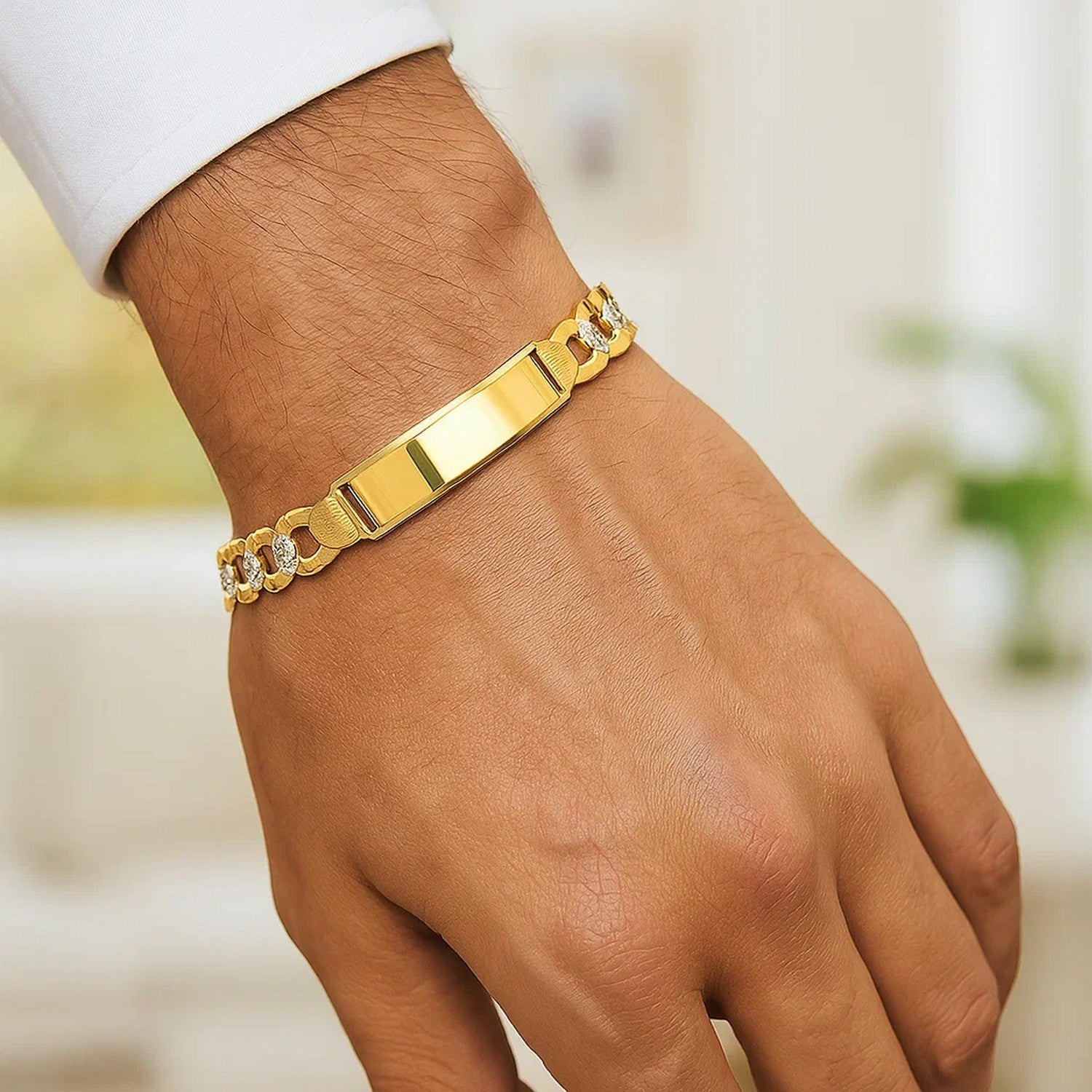 14k yellow gold pave curb ID bracelet with a polished rectangular plate on a man's wrist.