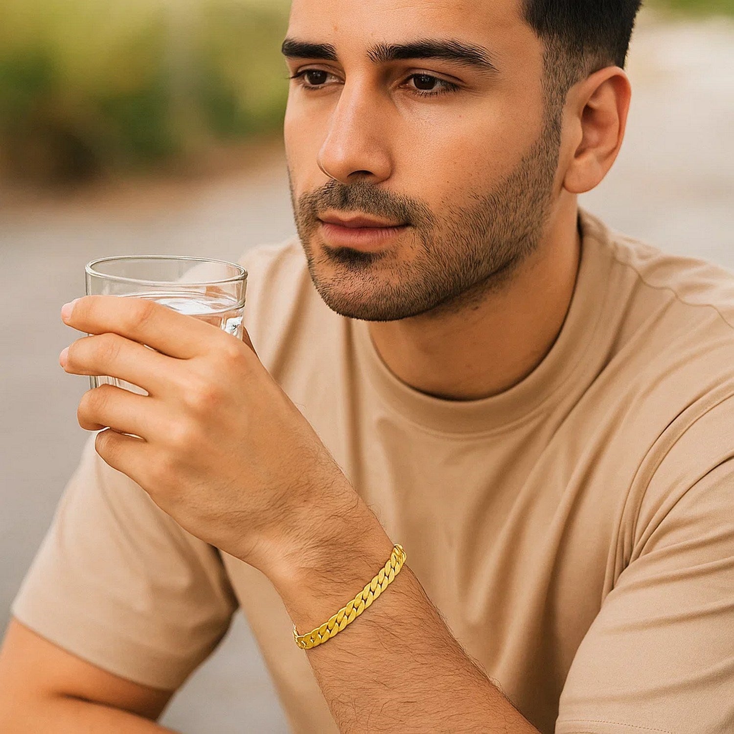 14k yellow gold 8-inch men's curb chain bracelet on a man's wrist.
