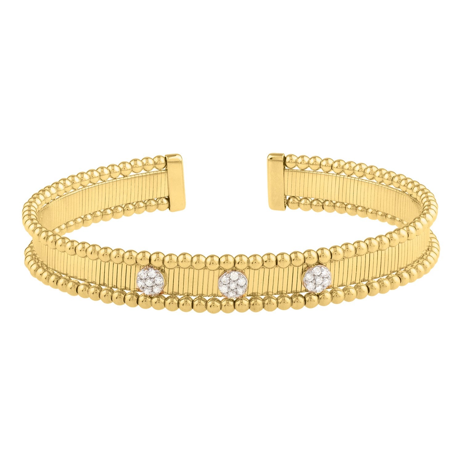 A two-toned 14K gold cuff bangle with three diamond-encrusted flower-like embellishments.