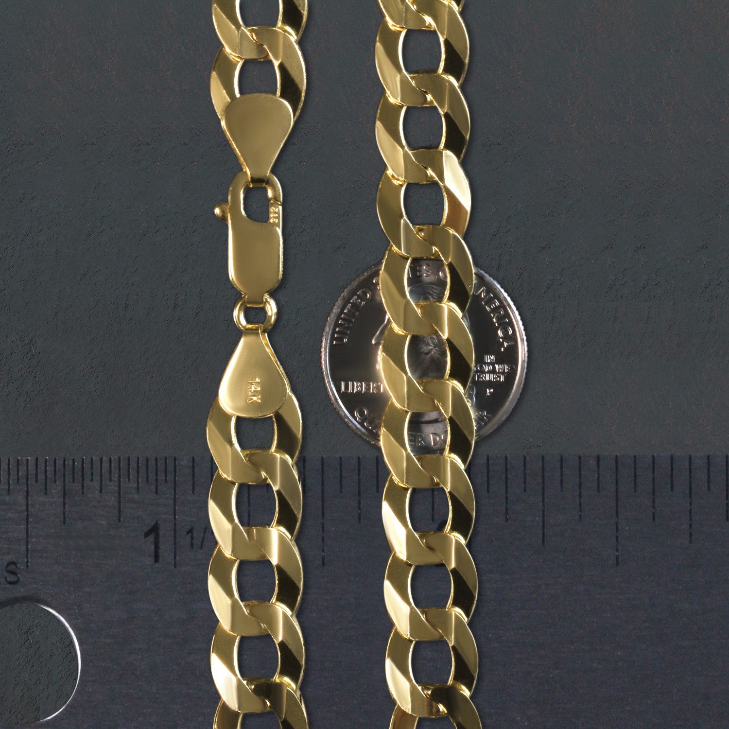 A solid 14k yellow gold curb chain with a lobster clasp, shown with a ruler and coin for scale.