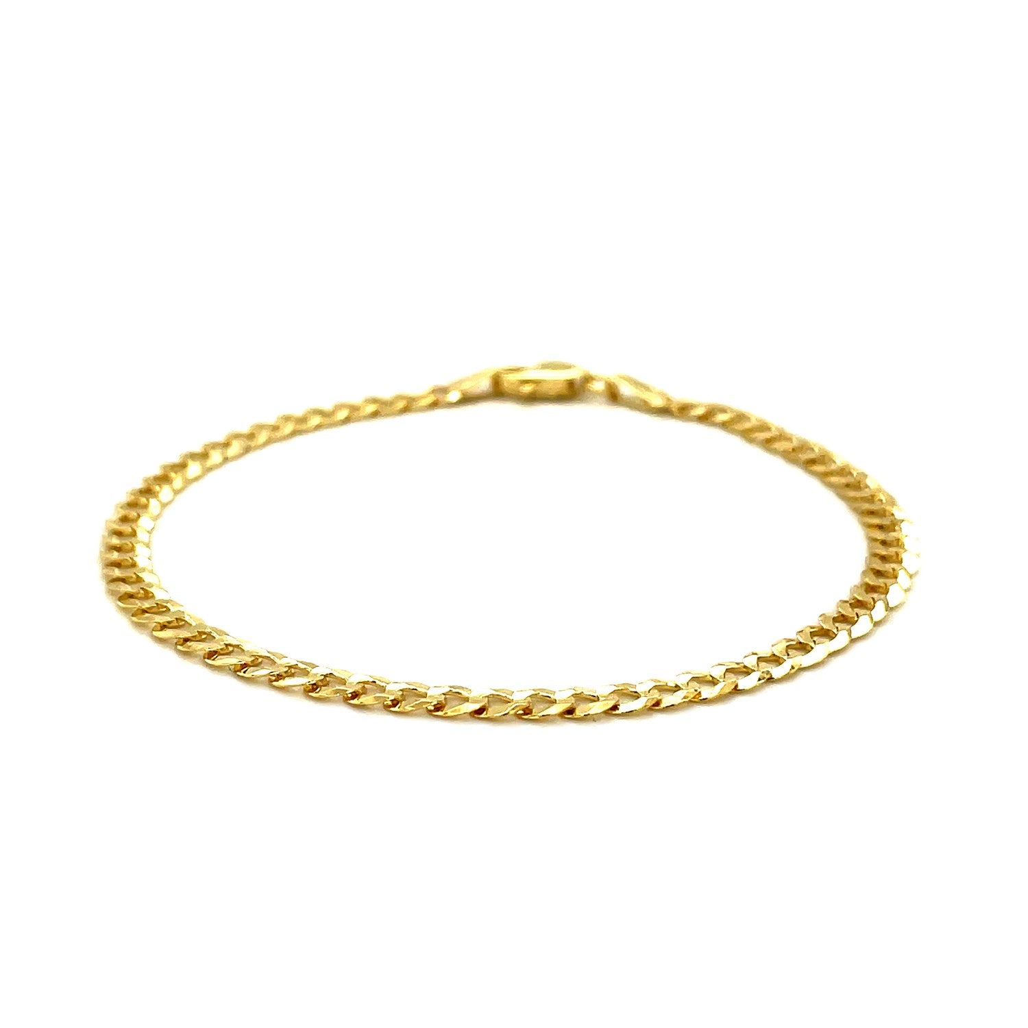 A 14k yellow gold solid curb bracelet with a lobster clasp.