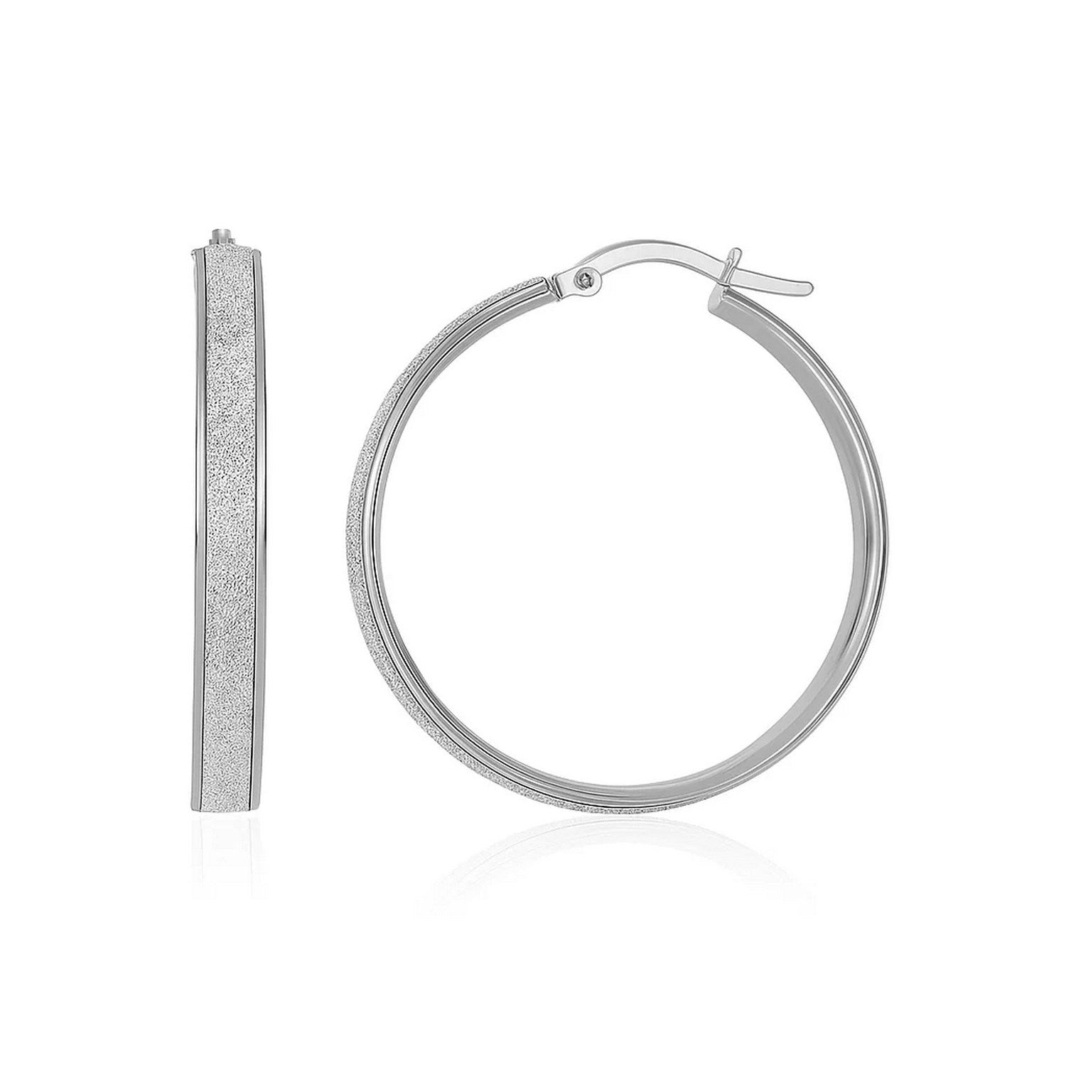 A pair of white tone gold hoop earrings with a glitter-look center design.