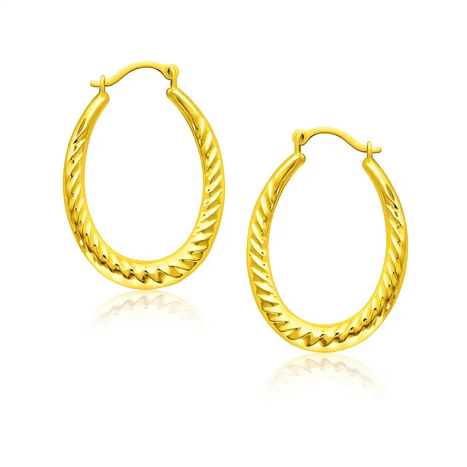Pair of 14k yellow gold oval hoop earrings with textured details.