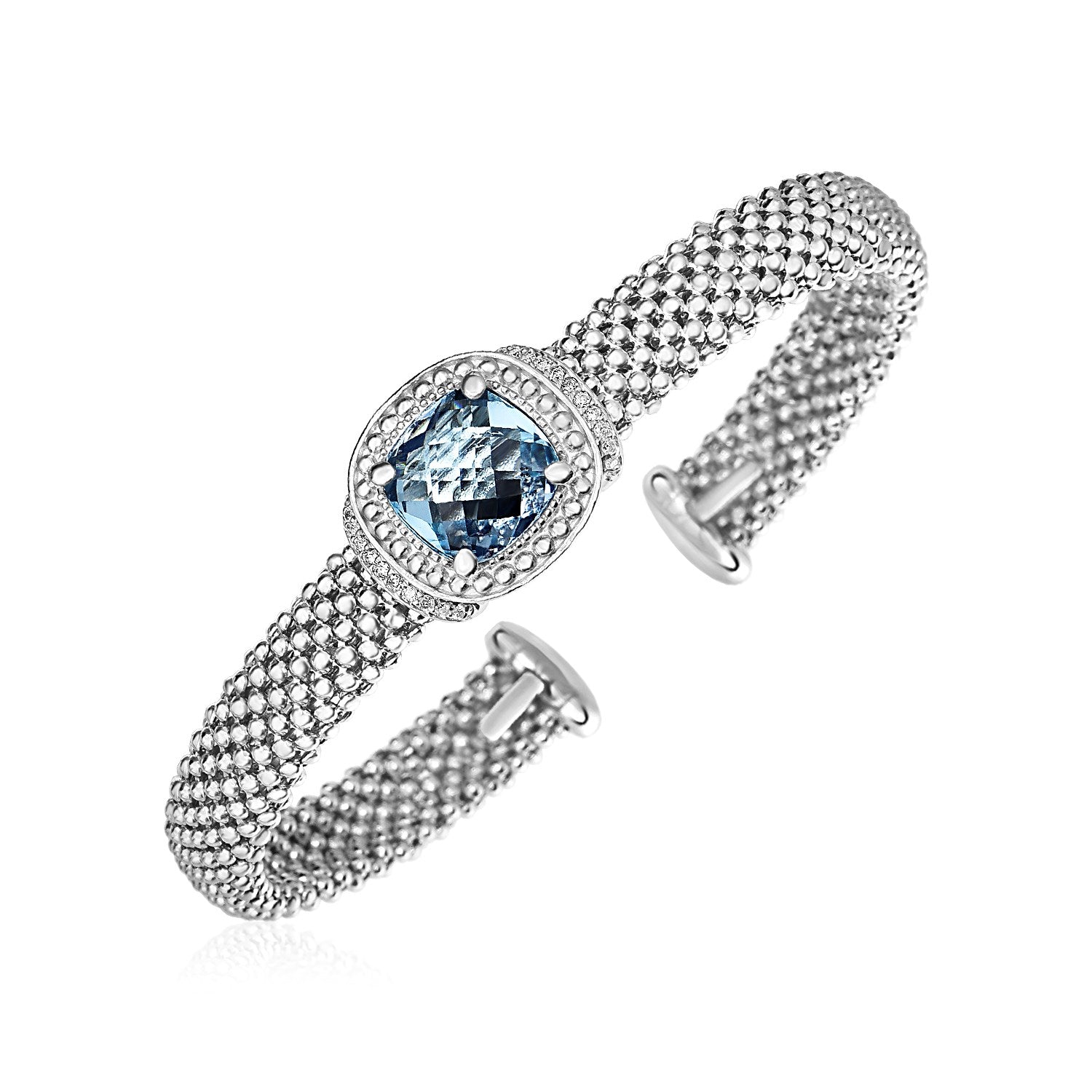 Sterling silver popcorn texture cuff bangle with a cushion-cut blue topaz and diamonds.