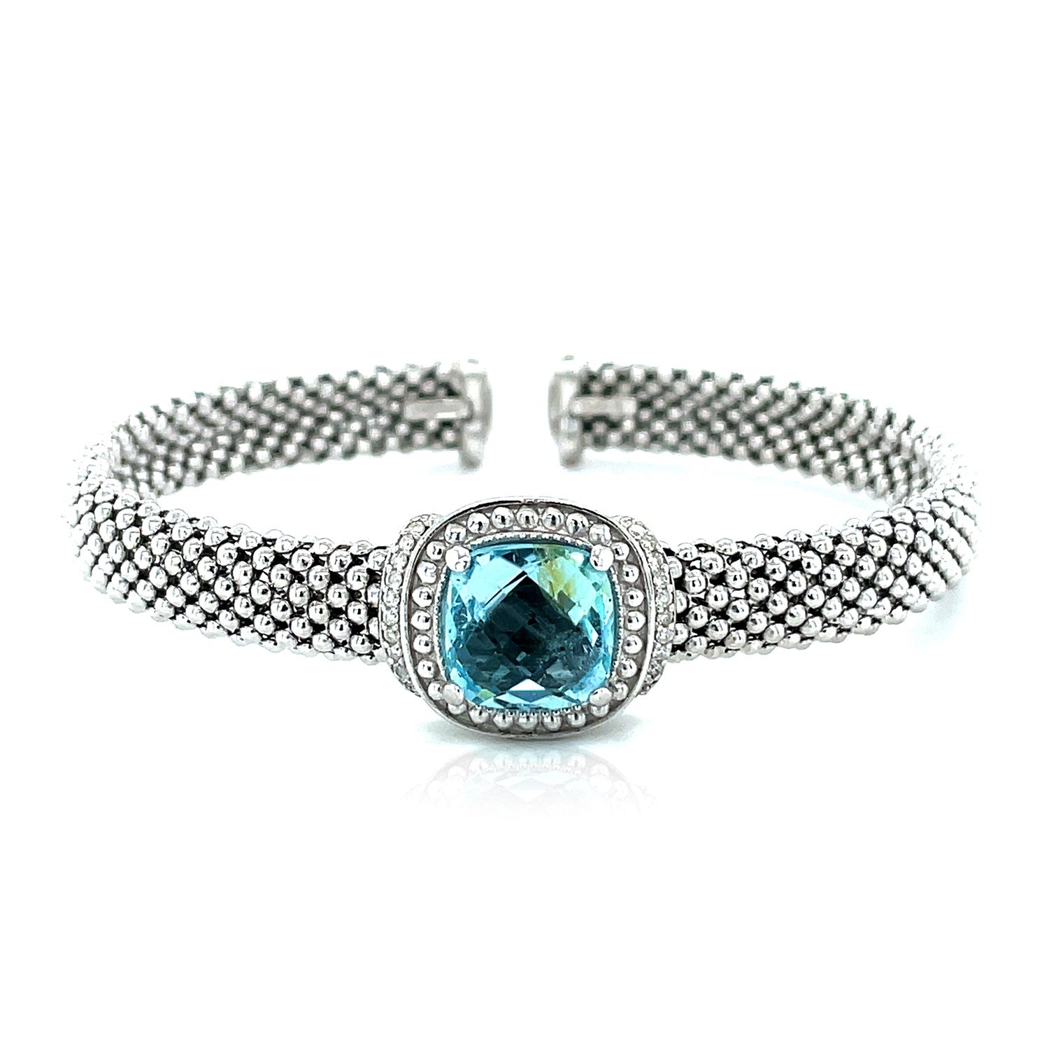 Sterling silver popcorn texture cuff bangle with a cushion-cut blue topaz and diamonds.