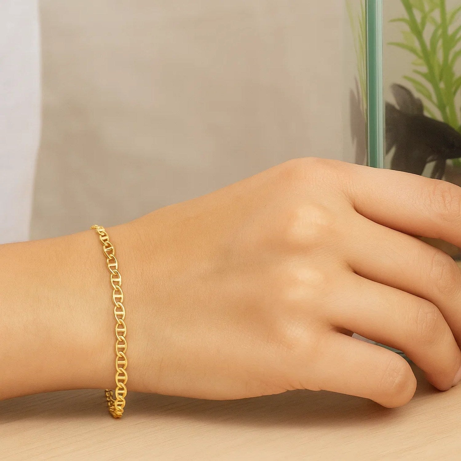 10k yellow gold mariner link bracelet on a person's wrist.