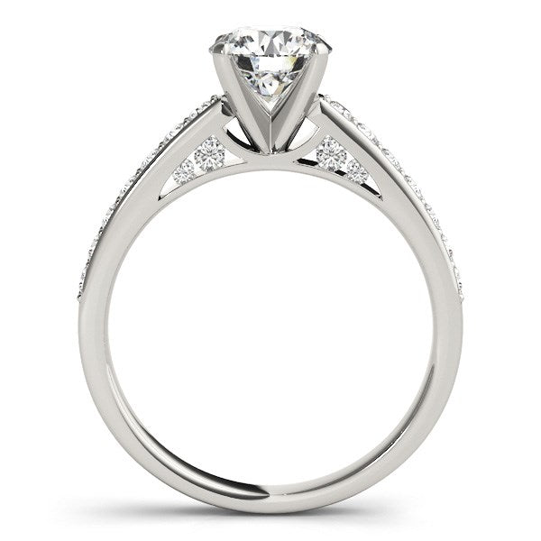 14k white gold engagement ring with a round center diamond and pavé side stones.