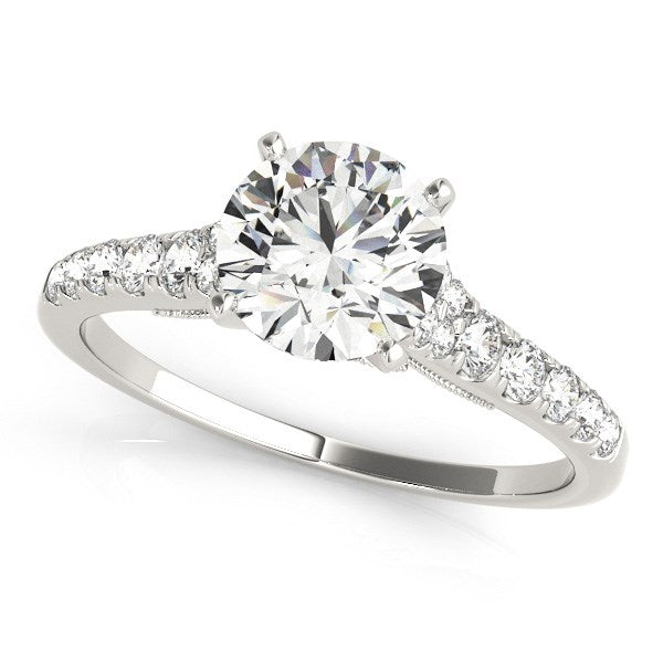 A 14k white gold engagement ring with a large round diamond and a single row of smaller diamonds on the band.
