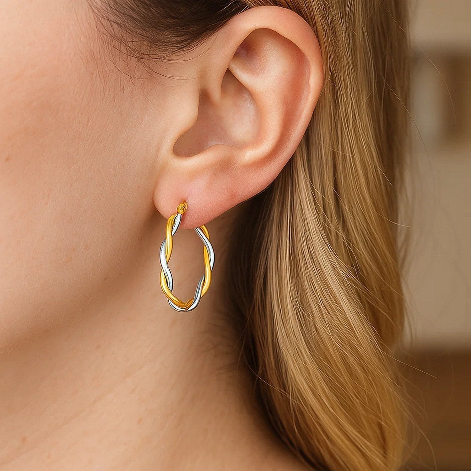 Two-tone twisted wire round hoop earrings in 10k yellow and white gold.