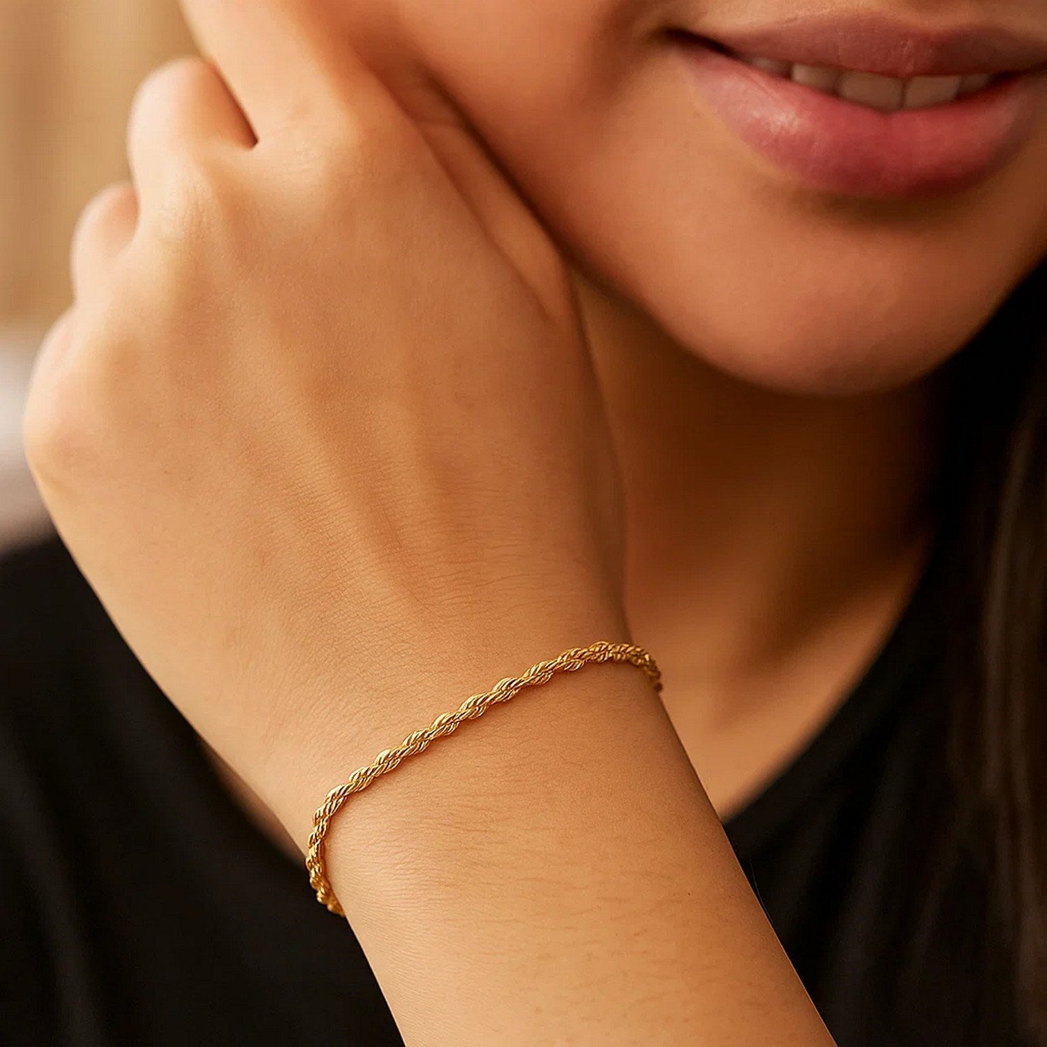 A 10k yellow gold lite rope chain bracelet on a person's wrist.