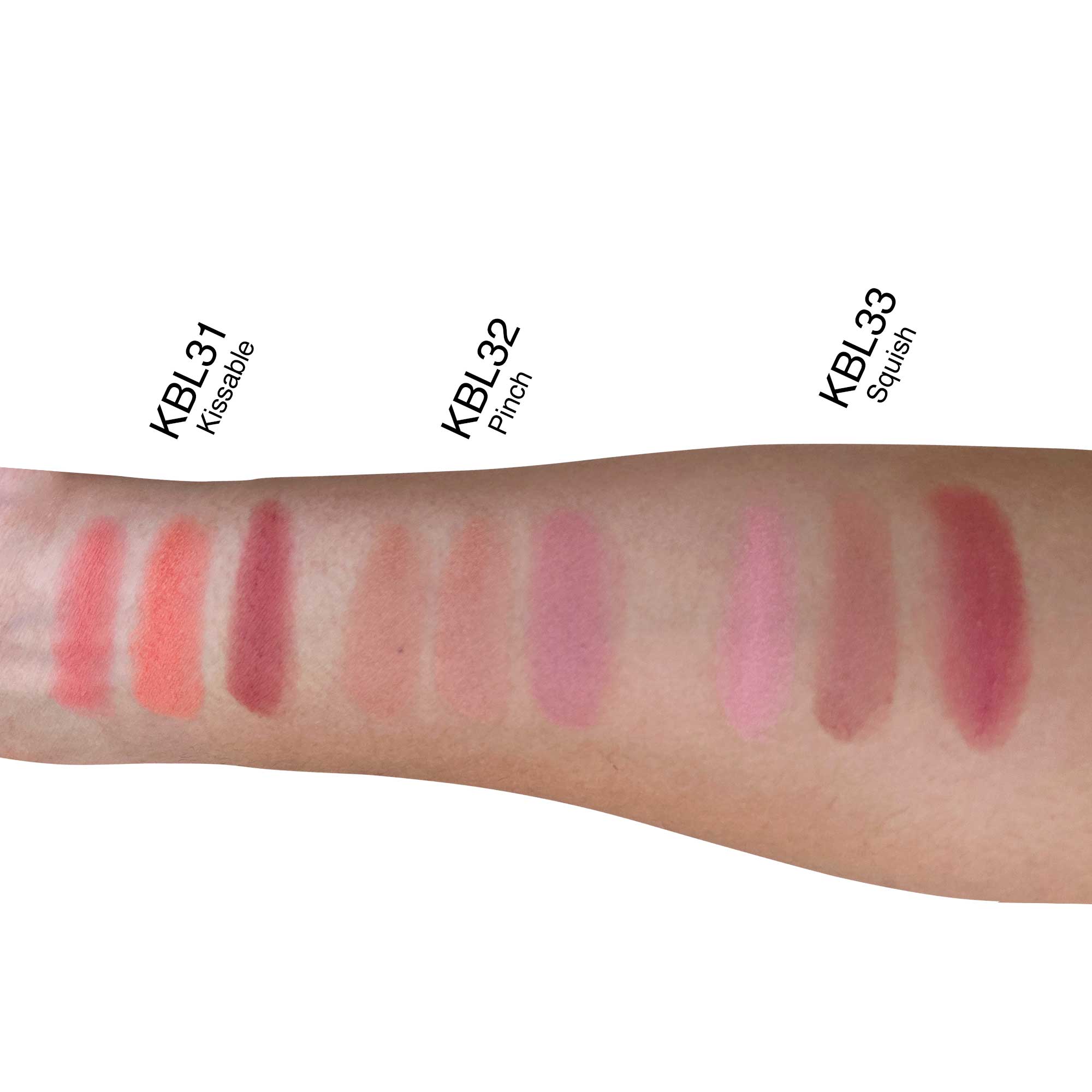 An arm displays 9 swatches of blush in varying shades of pink, peach, and red.